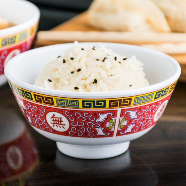 A bowl of rice in a Thunder Group Longevity melamine bowl with black sesame seeds.