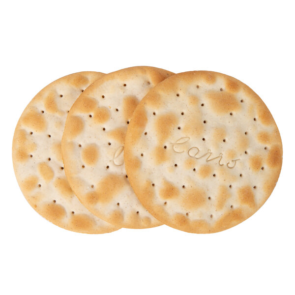 A close-up of Carr's Table Water crackers with the word "biscuits" on them.