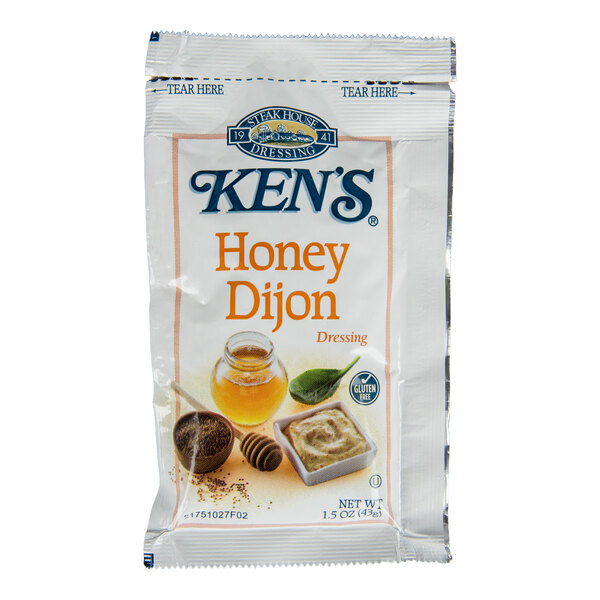A single-serve packet of Ken's Honey Dijon Dressing with images of honey, mustard seeds, and a small dish of dressing on the front.