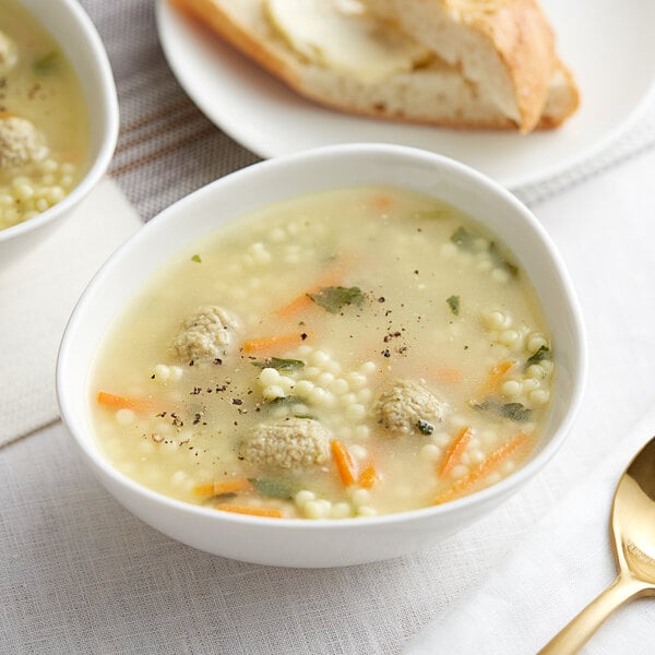 A bowl of Spring Glen Italian Wedding Soup with meatballs and vegetables.