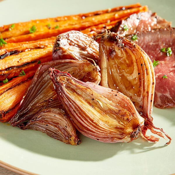 A plate of food with Unpeeled Shallots on a table.