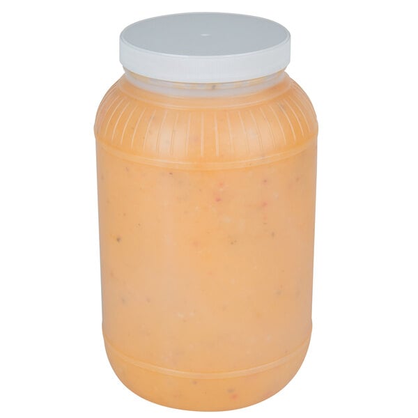 A plastic jar of Ken's Foods Golden Italian Dressing with a white plastic lid.