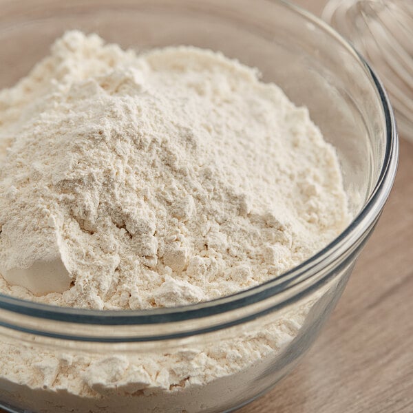 A bowl of King Arthur Organic Whole Wheat Flour with a whisk.
