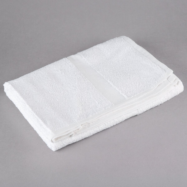 An Oxford white bath towel on a gray surface.