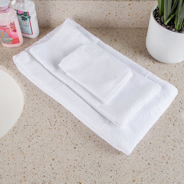 A white Oxford bath towel on a white counter.