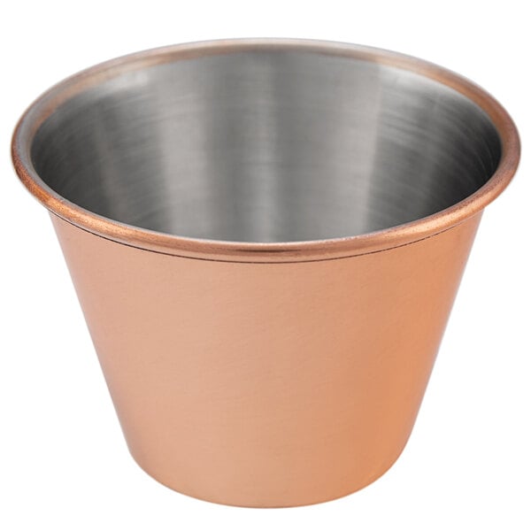 A close up of a copper cup with a silver rim.