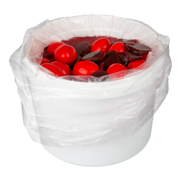 A white plastic tub containing pickled red beet eggs, partially covered with a clear plastic liner.