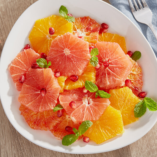 A plate of grapefruit slices on a table.