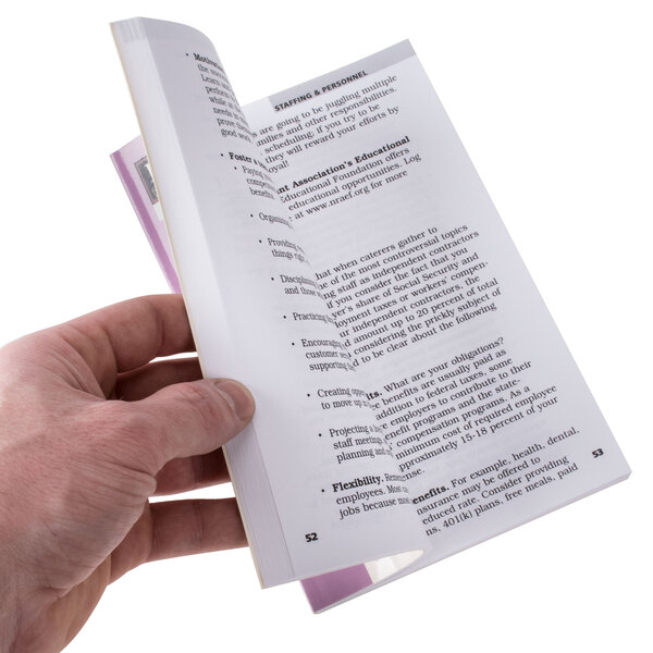 A person holding open Successful Catering book.