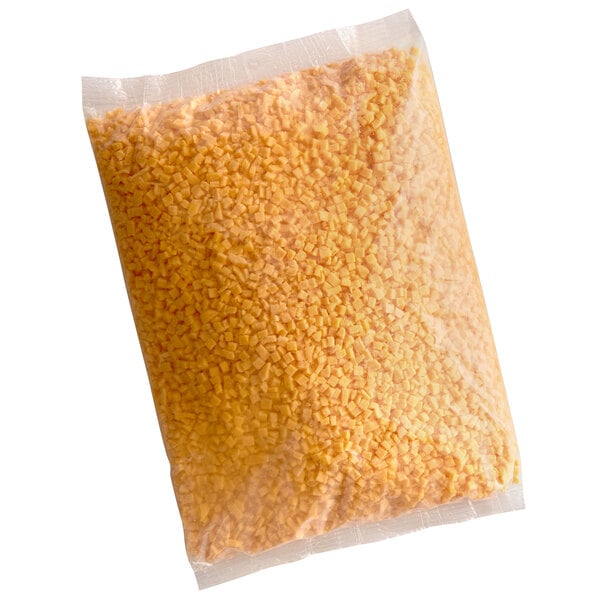 A plastic bag of diced yellow cheddar cheese.