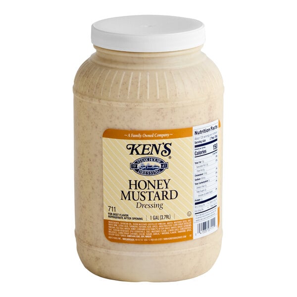 A 1-gallon plastic jar of Ken's Foods honey mustard dressing with a white screw-on lid.