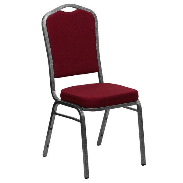 A Flash Furniture Hercules banquet chair with a red fabric cushion and silver metal frame.