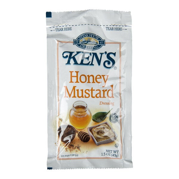A single-serve packet of Ken's Honey Mustard Dressing with images of honey, mustard, and spices on the front.