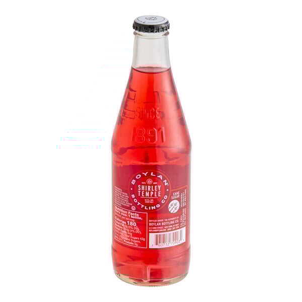 A 12 fl. oz. glass bottle of Boylan Bottling Co. Shirley Temple soda filled with bright red liquid.