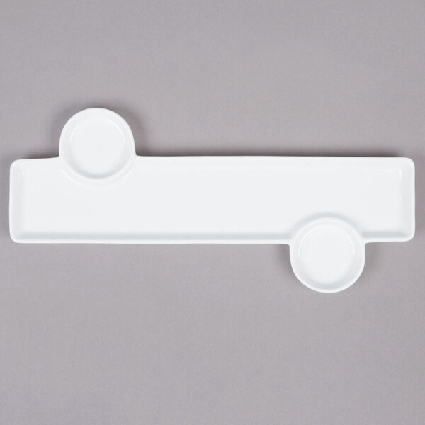 A white rectangular porcelain tray with two round sauce cup holders.