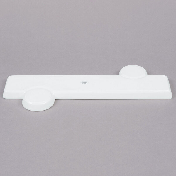 A white rectangular porcelain tray with sauce cups.