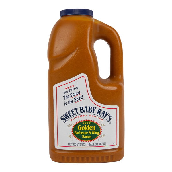 A large plastic jug with a handle, filled with golden-colored barbecue and wing sauce, featuring a label that reads 'Sweet Baby Ray's Golden Barbecue & Wing Sauce.'