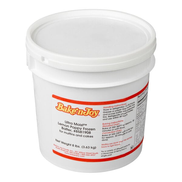 A white plastic tub with a lid and a red and white label displaying product information for Bake'n Joy lemon poppy frozen batter.