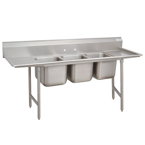 A stainless steel Advance Tabco 3 compartment sink with two drainboards.