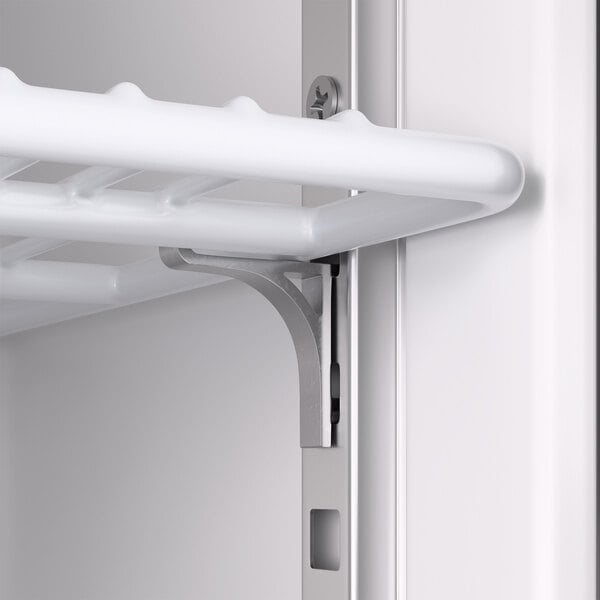 A close-up view of a white wire shelf supported by a metal bracket inside a cabinet or refrigerator.