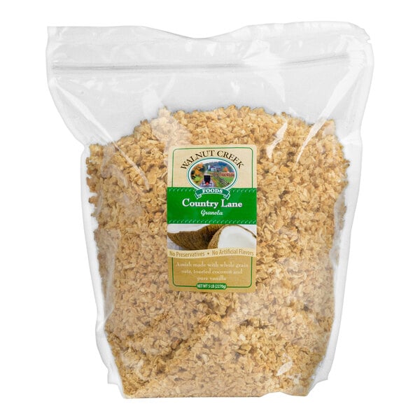 A clear plastic bag filled with granola, featuring a green and yellow label on the front.