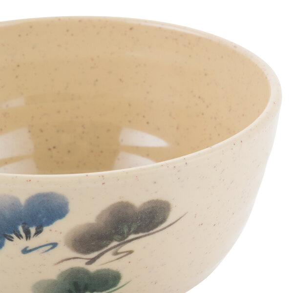 A white melamine bowl with blue flowers on it.