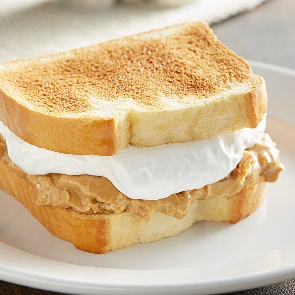 A sandwich on a plate with Jet-Puffed Marshmallow Creme and peanut butter on top.