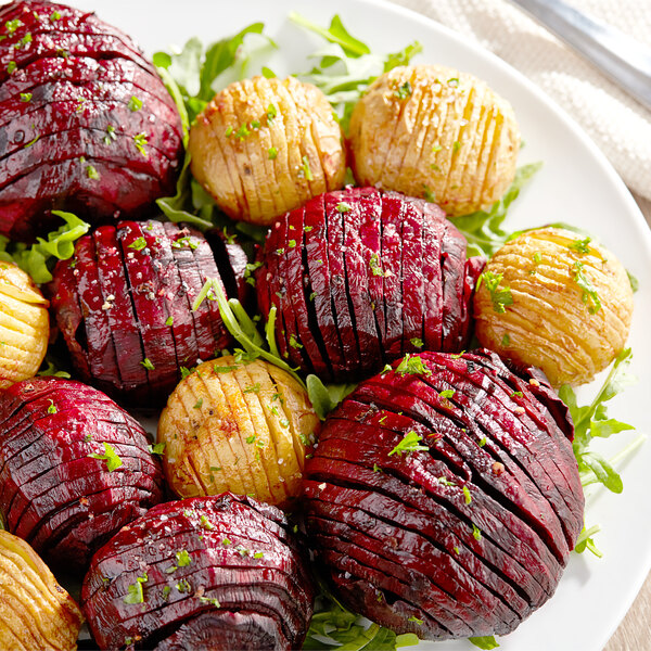 A plate of roasted red and green vegetables.