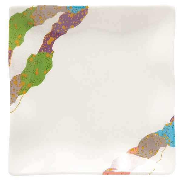 A white square GET petite plate with wavy edges and colorful designs.