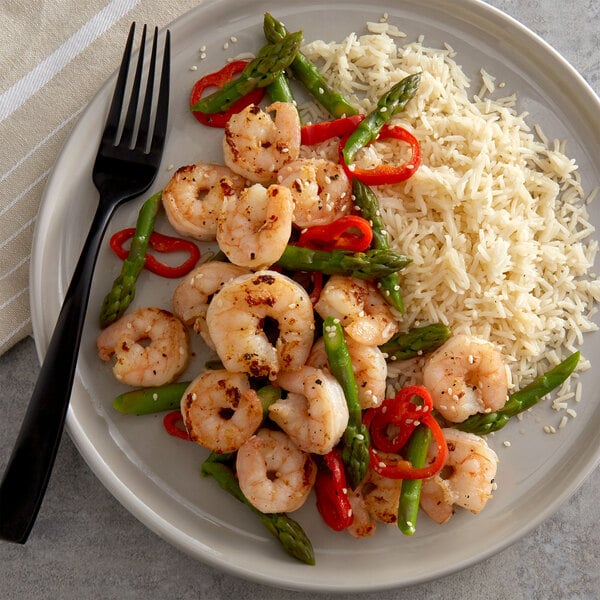 A shrimp entree paired with rice and green vegetables