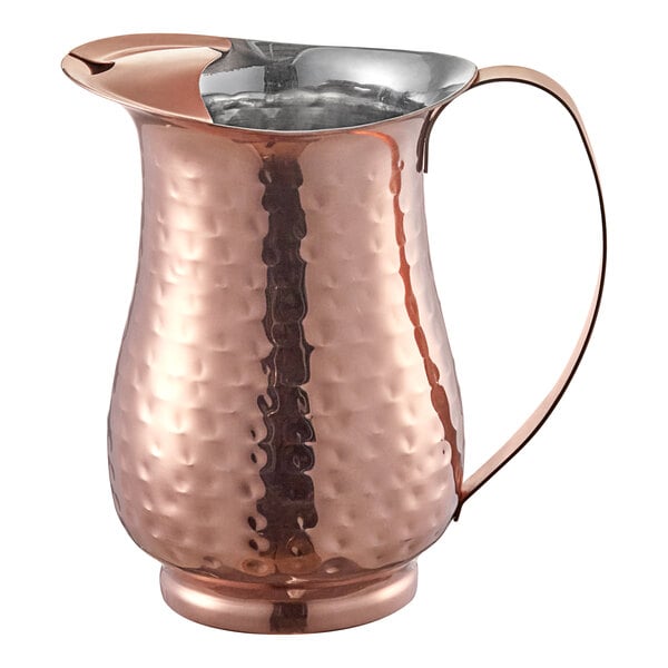 An Acopa hammered copper pitcher with a handle.