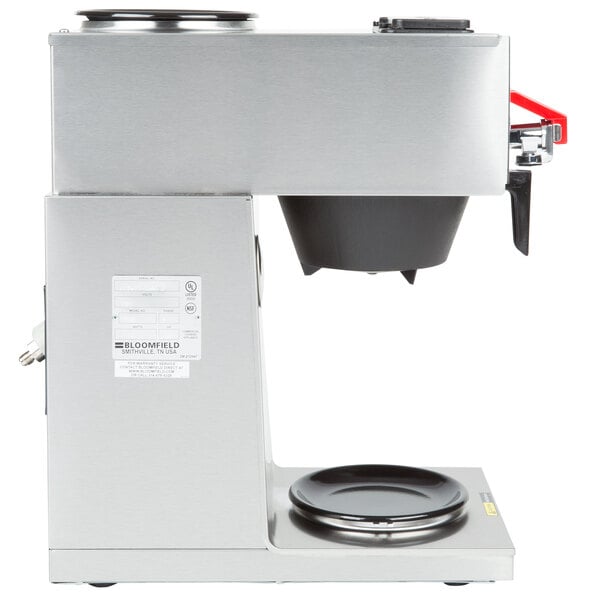 A silver coffee maker with a black and red handle.