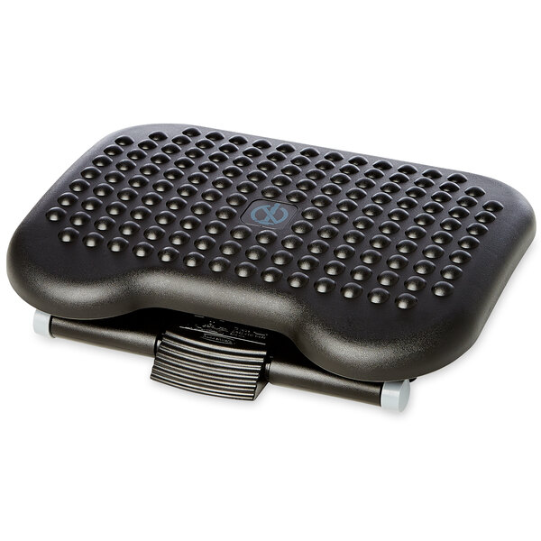 A black Rubbermaid plastic footrest with holes in it.