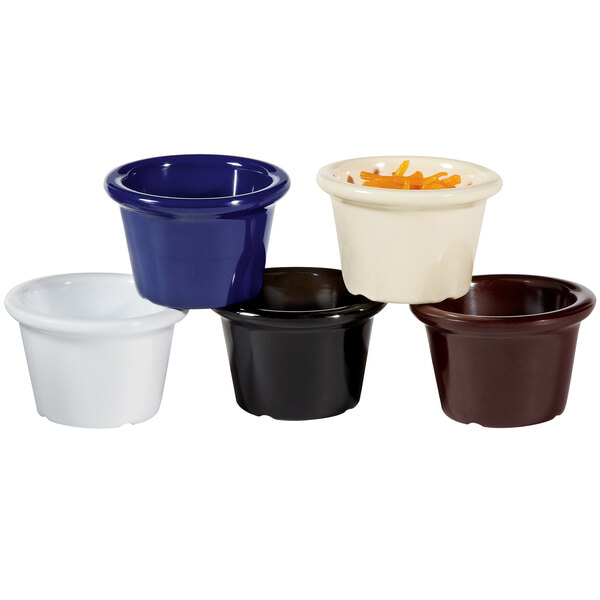 A black ramekin filled with orange food.