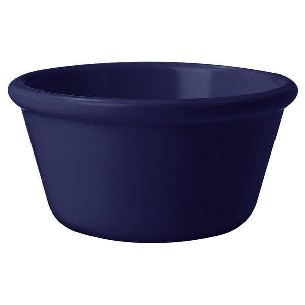 A cobalt blue melamine ramekin with a white background.