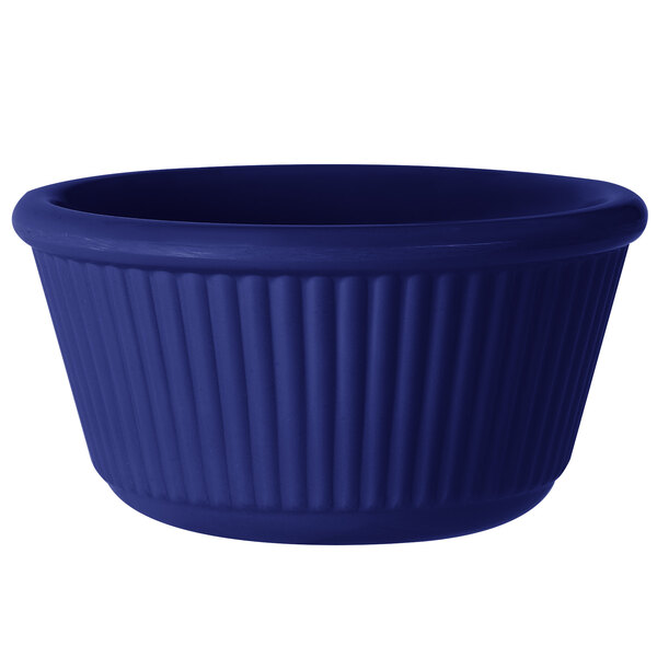 A cobalt blue fluted melamine ramekin.