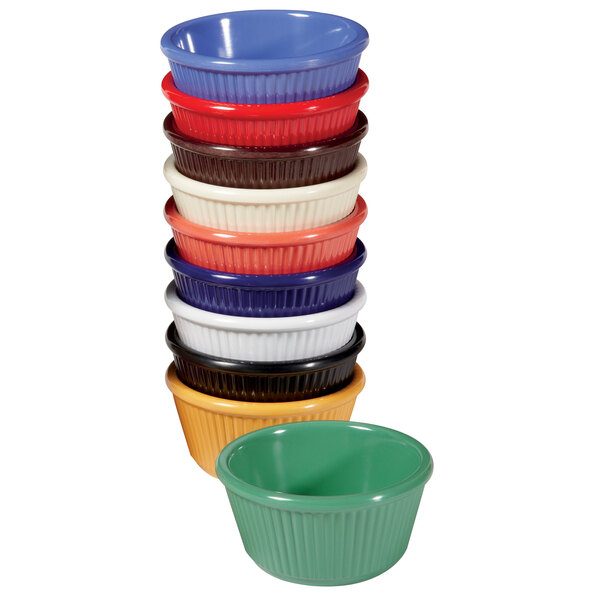 A stack of red, blue, and green fluted melamine ramekins.