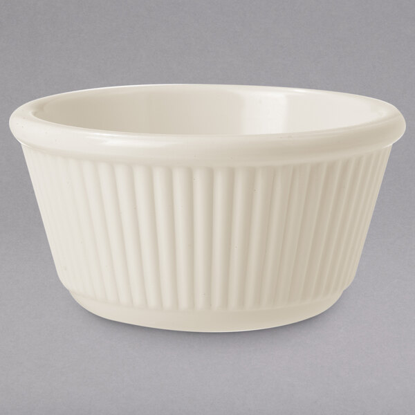 An ivory fluted ramekin on a white background.