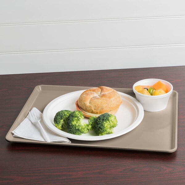 A Cambro taupe dietary tray with a plate of food and a drink.