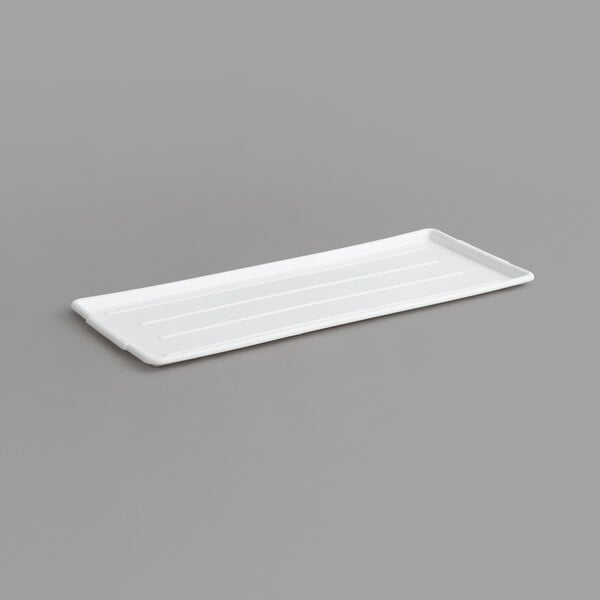 A white rectangular Channel plastic platter with ribbed lines.