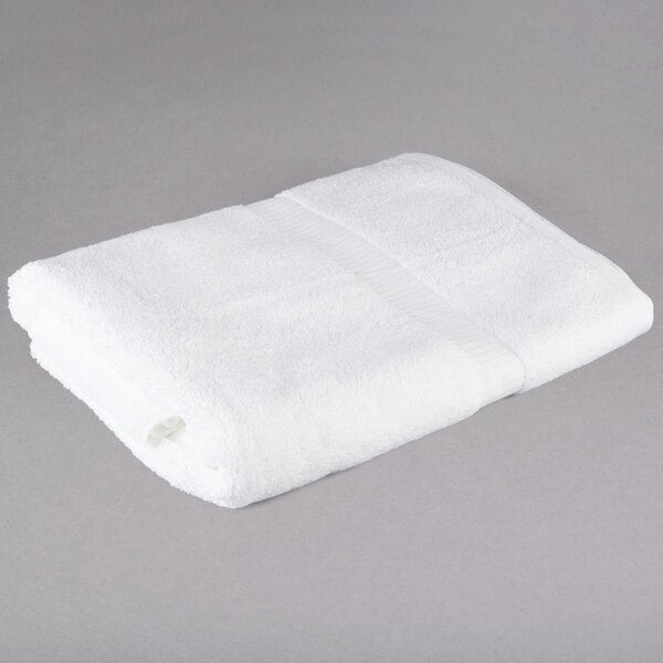 A white Oxford Belleeza bath towel on a gray surface.