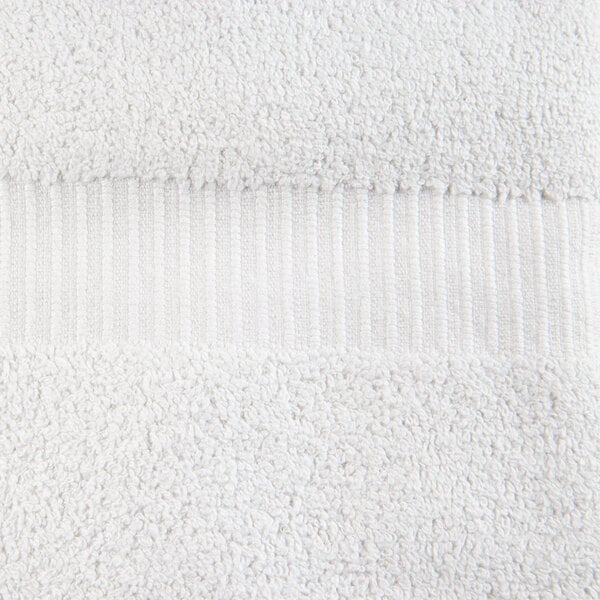 A close up of a white Oxford Belleeza bath towel with a stripe.