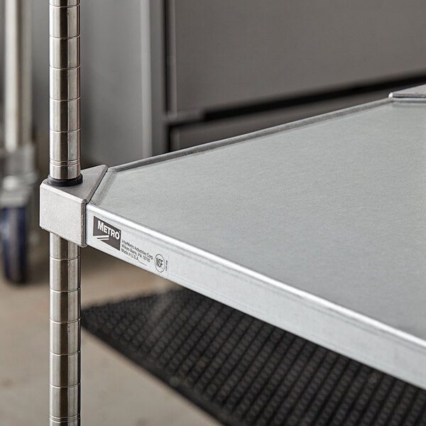 A Metro flat galvanized solid shelf with metal rods.