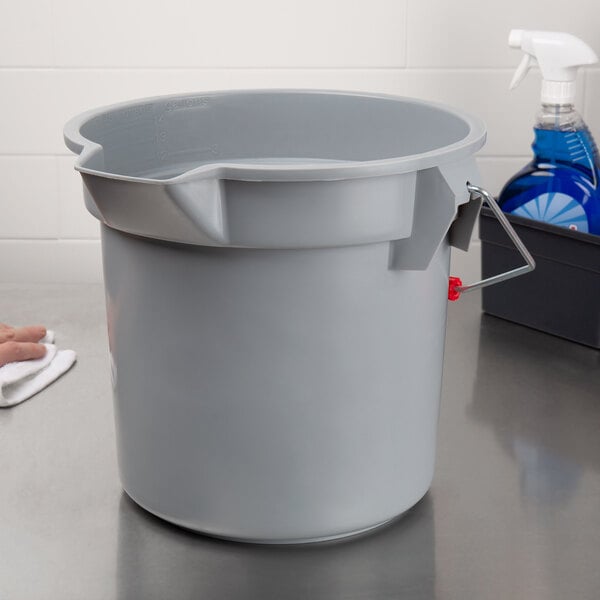 A Rubbermaid Brute grey bucket on a counter.