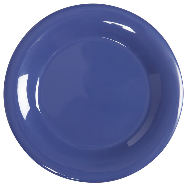 A close up of a GET Diamond Mardi Gras peacock blue melamine plate with a wide rim.