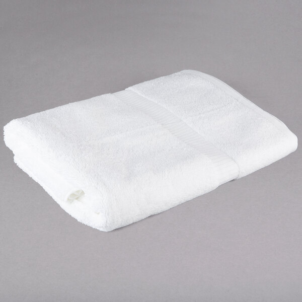 A white Oxford Belleeza bath towel on a gray surface.