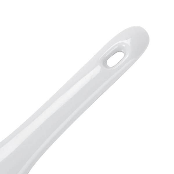 A white handle of a utensil.