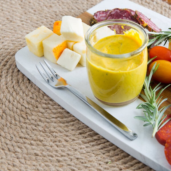 A plate of food with a Libbey cocktail fork and knife.