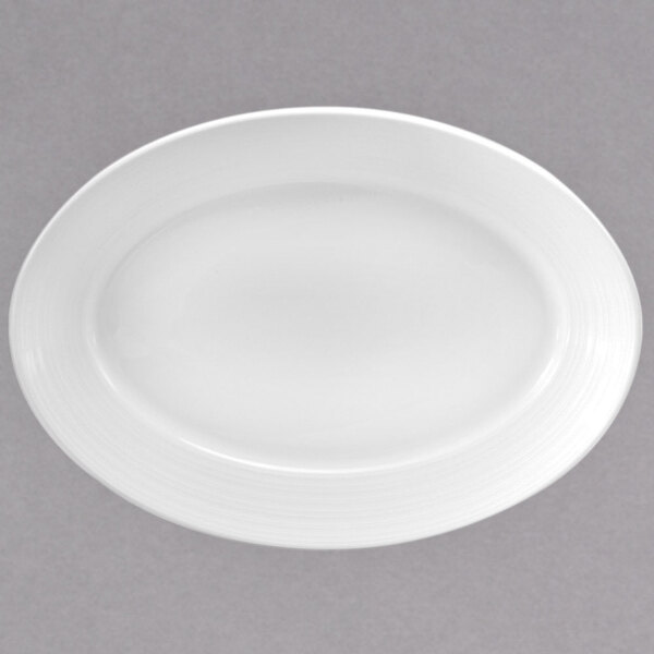 A white oval porcelain platter with a white rim.