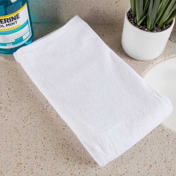 A white Oxford Platinum bath towel with a Dobby twill border on a counter.